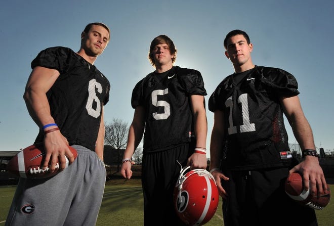 In this Feb. 26 photo, Georgia quarterbacks Logan Gray (6), Zach Mettenberger (5) and Aaron Murray (11) pose for a photo in Athens, Ga. A week from the Bulldogs' G-Day game, all three of the young quarterbacks have played well in drills.