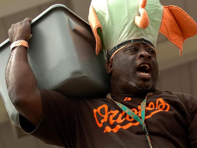 Beerman Darryl Johnson hawks his products during a recent Orioles-Yankees matchup at Ed Smith Stadium. Today is the final spring training game of the season in Sarasota – and the last chance to catch Johnson's beer pitch, at least for a while.