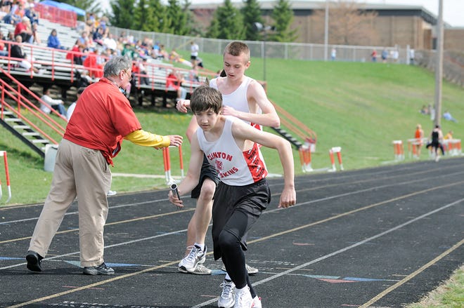 Clinton’s Justin Swisher takes off after receiving the baton from Ryan Rogers during the 6,400-meter relay at Saturday’s Clinton Relays. The Clinton boys had four first-place finishes in the meet.