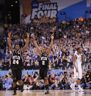 Butler players Avery Jukes (24) and Shawn Vanzant (2) celebrate as Michigan State's Raymar Morgan walks off the court after Butler's Final Four victory on Saturday, April 3, 2010, in Indianapolis.