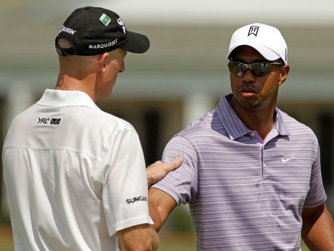 Tiger Woods, right, chats with Jim Furyk at the Augusta National Golf Club, the site of the Masters golf tournament in Augusta, Ga., on Sunday, April 4, 2010.