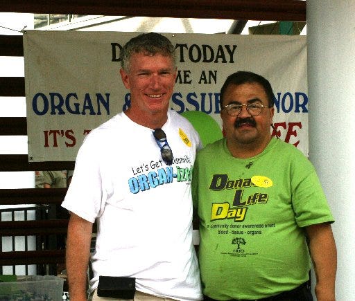 Donate Life Day organizer Steve Vandergriff (left) stands alongside his buddy, kidney recipient German Vivas, at the Jacksonville Landing.