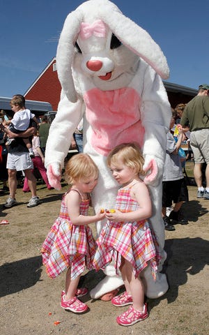 The Easter bunny gets a double hug from 2-year-old twins Ryleigh and Camryn Cox of Marlborough during yesterday's Easter egg hunt at Ghiloni Park in Marlborough.