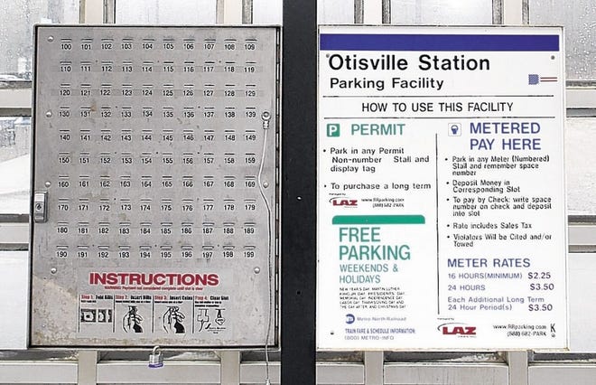 The parking pay station at the train station in Otisville is a central stand of numbered slot boxes.