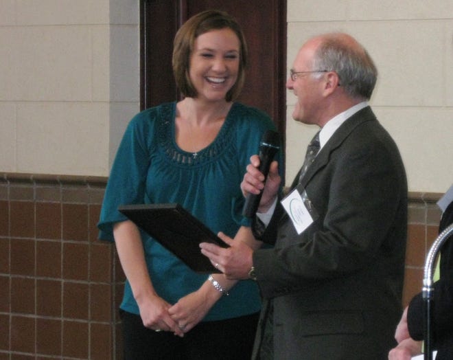 Jessica Drew laughs as Dick Kline, vice-chair of Safe Streets Coalition, presents the television reporter with a Champion of Character award Wednesday at the Great Overland Station.