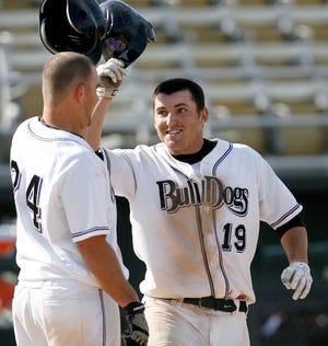 SCI's Kyle Krager, right, is congratulated his teammate, Trevor McGrath, left, after hitting a home run against Danville at Robin Roberts Stadium in Springfield, Ill., Friday, April 2, 2010. Justin L. Fowler/The State Journal-Register