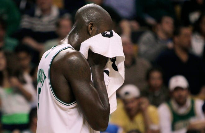 Kevin Garnett wipes his face during a time out while trailing the Wizards by 28 points during the second quarter the Celtics' loss on Friday night at the Garden.