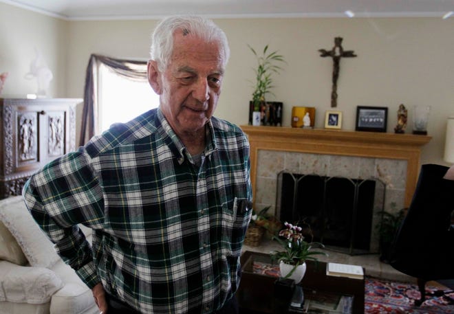 John S. Cummins, former bishop of the diocese of Oakland, Calif., looks 
over copies of documents brought to his home Friday.ASSOCIATED PRESS / 
MARCIO JOSE SANCHEZ