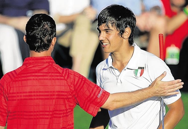 Sixteen-year-old Italian amateur Matteo Manassero, right, is congratulated by Mike Weir after making the cut at the Masters.