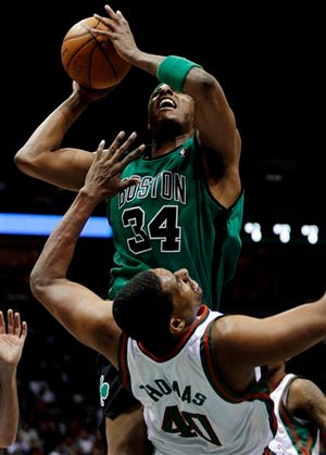 Boston Celtics' Paul Pierce, back is charged with a offensive foul against Milwaukee Bucks' Kurt Thomas, front, in the first half in an NBA basketball game Saturday, April 10, 2010, in Milwaukee. (AP Photo/Darren Hauck)