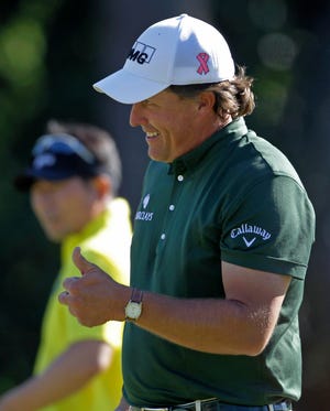 Phil Mickelson gives a thumbs up after his eagle on the 14th hole during the third round of the Masters golf tournament in Augusta, Ga., Saturday, April 10, 2010. (AP Photo/Morry Gash)