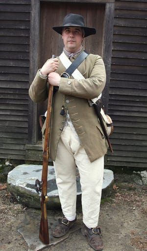 At the Hartwell Tavern Historic Area in Battle Road (along Rte. 2A in Lincoln), Jim Hollister poses as a militia man... He is a National Park Ranger.