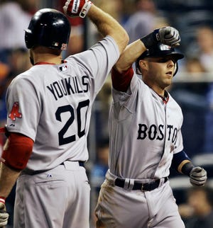 Boston's Dustin Pedroia (right) is congratulated by Kevin Youkilis after a two-run home run during the ninth inning of the Red Sox' 8-3 win over the Royals.