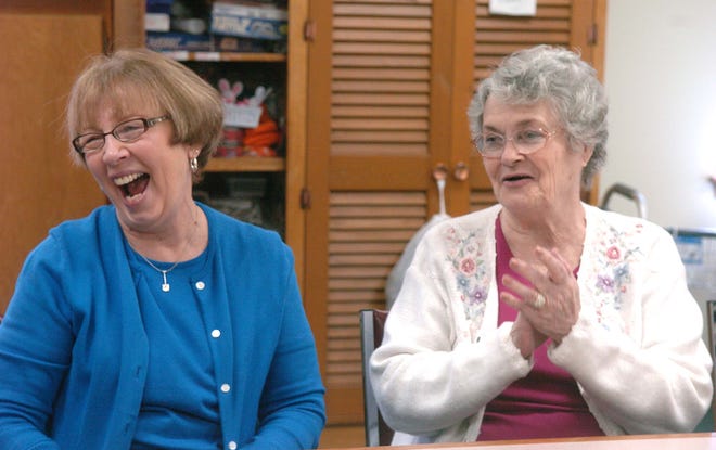 Sue Renaud, coordinator of the West Bridgewater Council on Aging and Mae Gerrish share a laugh before their meal.