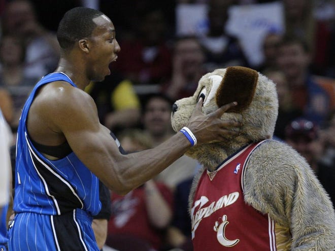Orlando Magic's Dwight Howard, left, grabs the head of Cleveland
Cavaliers mascot "Moon Dog" in the fourth quarter Sunday in Cleveland. Howard and the Magic defeated the Cavaliers 98-92.