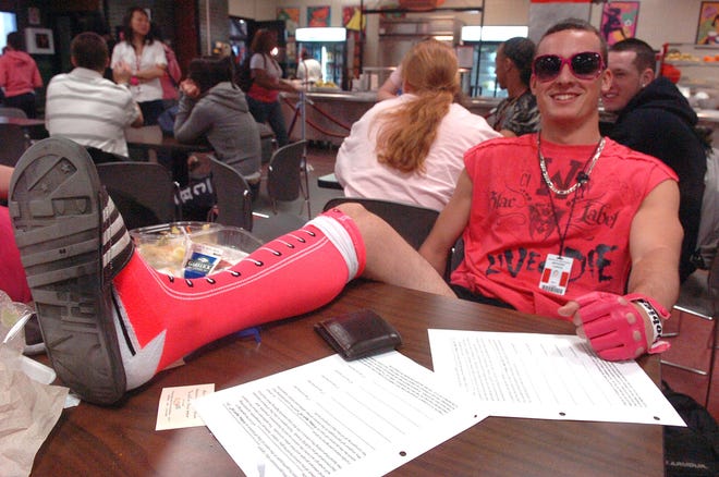 Anthony Lupica, 17, a junior at Brockton High School, wears pink socks, glasses, gloves and a T-shirt while having lunch in the cafeteria on Wednesday to show his support for the anti-bullying campaign, a Day of Pink.