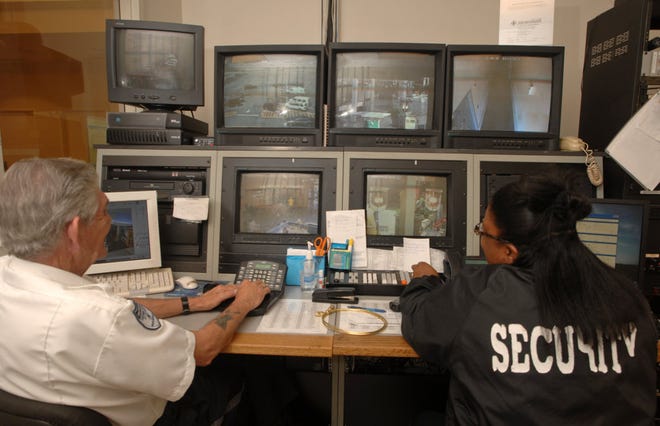 Assistant director of security Larry Raper, left, and dispatch supervisor Melanie Jones monitor surveillance cameras in Oglethorpe Mall during a joint operation with Savannah-Chatham Metro Police. (John Carrington/Savannah Morning News)