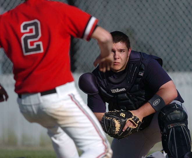 Woodstock catcher Zak Cozey, right, waits at home plate, with the ball, to tag out Fitch's David Hall during a baseball game at Fitch High School in Groton Wednesday, April 14, 2010.