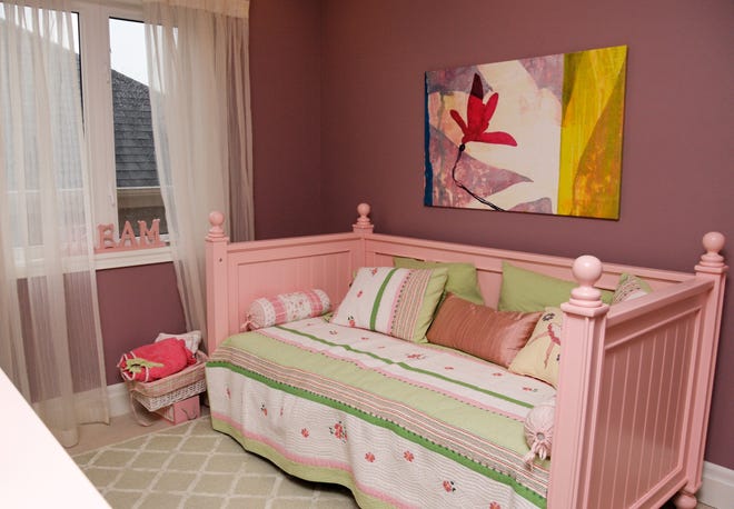 A daybed is a versatile choice for a young lady's bedroom, doubling as a place to play and sleep.