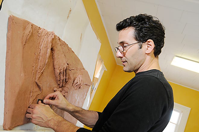 Sculptor Antonio Francesco works on his sculpture March 18 in his temporary studio at St. Mary’s of Good Counsel Catholic Church in Adrian.