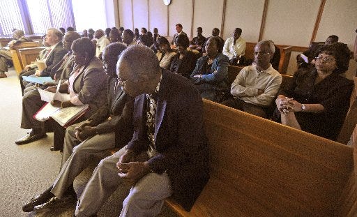 St. Johns Baptist Church members listen to testimony in the Duval County Courthouse Tuesday. An injunction has been requested to allow the congregation to continue worshipping, as the pastor and deacons say have been locked out of the church by the trustees.