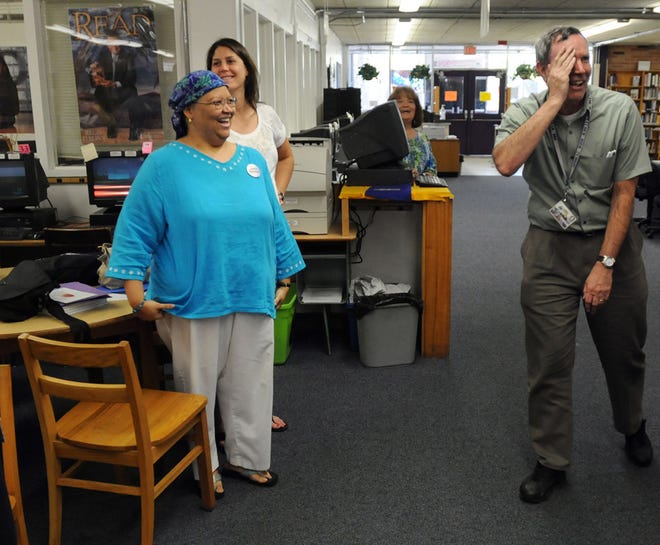 Timothy Allen (right), a Fletcher High teacher, reacts when he realizes that he was called to the school's media center to accept the Gladys Prior Award of Excellence.
