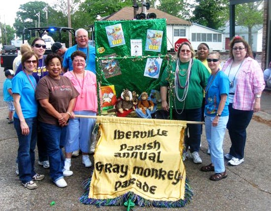 GRAY MONKEY PARADE...The annual Gray Monkey Parade, delayed due to unexpected snow in the area during the winter, was held in all its glory last week through Plaquemine. In the photo at left, members of the Iberville Parish Library, who sponsor the children’s parade each year, take a snapshot by the lead float, upon which the Gray Monkey rides the route. In the middle photo, a young parade participant supports Iberville’s anti-litter program, while in the right photo, a popular subject around the state is still being beloved...The NFL Champion New Orleans Saints!