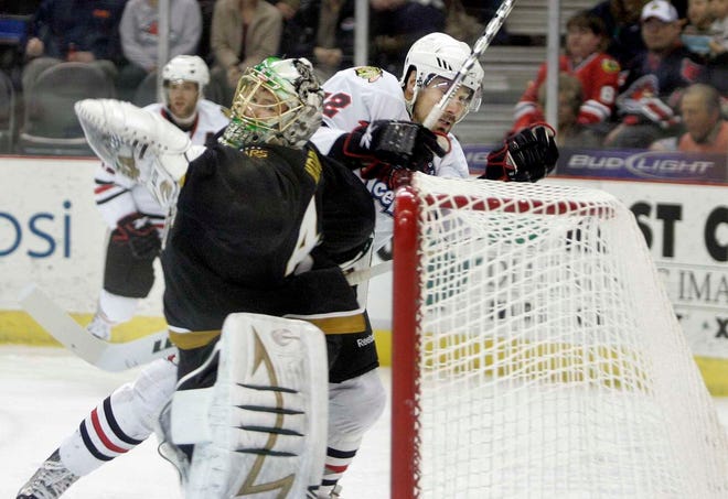 Rockford's Kyle Greentree tries to find a shortcut into the net over Texas goalie Brent Krahn during the IceHogs game against the Texas Stars at the MetroCentre in Rockford on Wednesday, April 21, 2010.