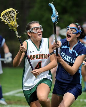 Hopkinton's Hannah Gibney (left) looks to pass while being defended by Franklin's Sarah Doherty during the Hillers' 7-5 win.