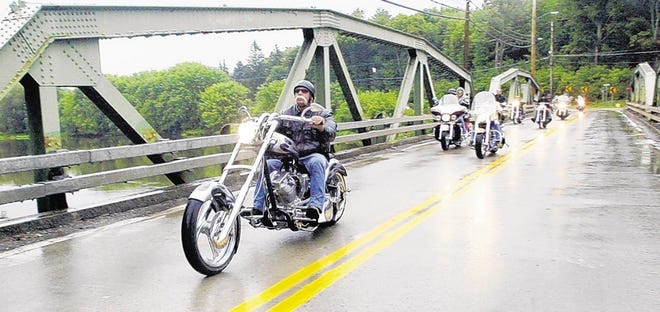 After a scenic ride with Orange County Choppers in 2006, Paul Teutul Sr. crosses over the Wallkill River steel bridge back into Montgomery with others following close behind.