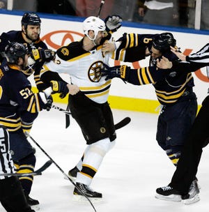 Buffalo Sabres' Cody McCormick, right, fights with Boston Bruins' Zdeno Chara (33) of Slovakia during the third period of a first-round NHL playoff hockey game in Buffalo, N.Y., Friday, April 23, 2010. The Sabres won 4-1. (AP Photo/ Dean Duprey)