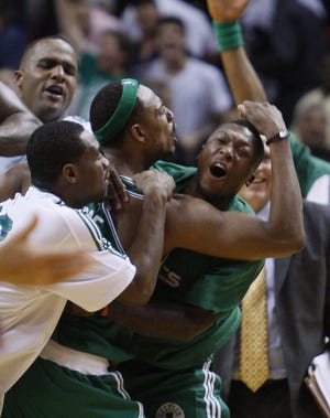 Celtics forward Paul Pierce (with headband) is mobbed after hitting the game-winning shot last night against the Heat, giving Boston a 3-0 lead over Miami in their first-round playoff series.