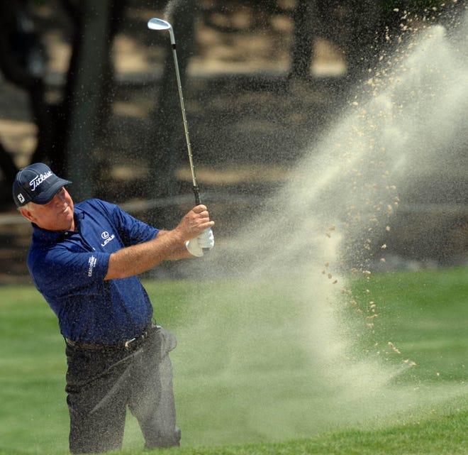 Mark O'Meara blasts from a bunker on the 15th hole Friday during the first round of the Liberty Mutual Legends of Golf. O'Meara and partner Nick Price finished with an 8-under par 64 to tie for the lead. Richard Burkhart/Savannah Morning News