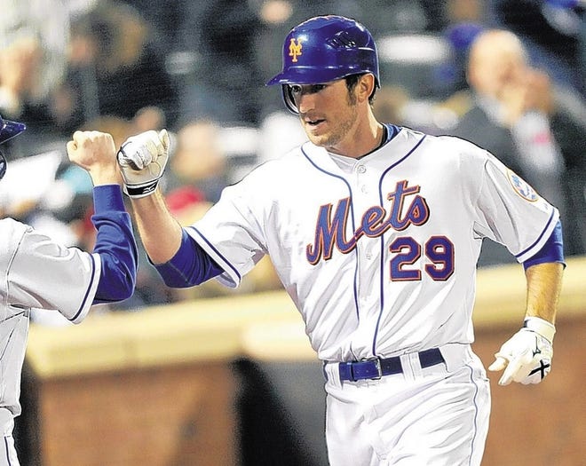 Mets' Ike Davis is greeted at the dugout after his towering home run in the fifth inning Friday against the Atlanta Braves.