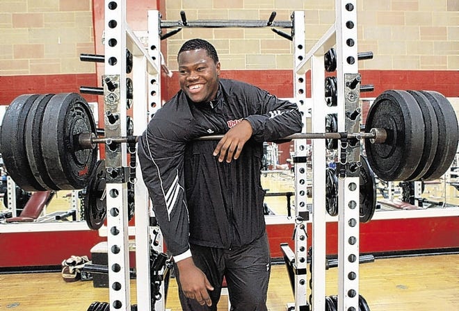 University of Massachusetts offensive tackle Vladimir Ducasse, originally from Haiti, smiles while having his photo taken in a gym on the school's campus, in Amherst, Mass., on Friday, Jan. 22, 2010. Ducasse, who has lived in the United States since he was 14, is headed to the Senior Bowl college all-star football game with thoughts of impressing pro scouts, and concerns about his native Haiti. (AP Photo/Steven Senne)