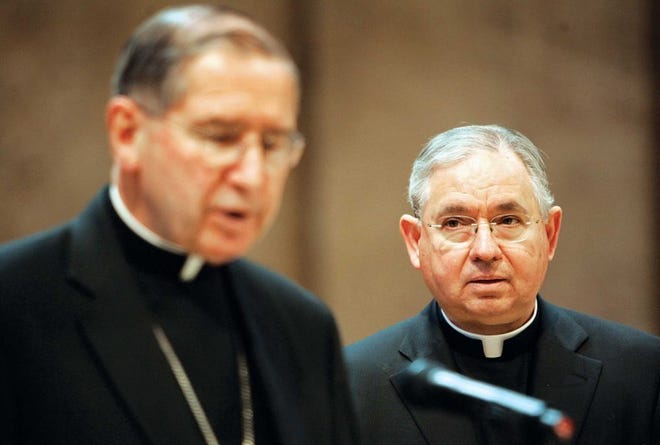 Cardinal Roger Mahony (left) introduces Archbishop Jose Gomez of San Antonio as his successor as head of the Los Angeles Archdiocese, the nation's most populous.