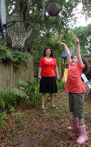 Marlee Vinzant plays in her backyard as her mom, Michelle Vinzant, watches Wednesday. Marlee suffers from epilepsy, which her family hopes to treat with a stem- cell treatment in Mexico. By DARON DEAN, daron.dean@staugustine.com