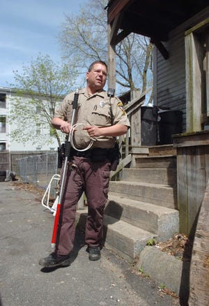 Brockton Control Officer Darren Hand exits a house on Crescent after a receiving a phone call that a pit bull attacked another dog. Animal control supervisor Thomas DeChellis says the career has changed over the years and "the days of the dog-catcher are over." In honor of National Animal Control Appreciation week, we're following a day in the life of an officer as he answers calls and rescues stray animals.