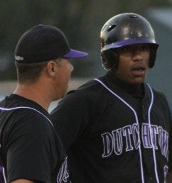 Dutchtown coach Chris Schexnaydre talks to junior Leon Blouin at third base in a game earlier this season. Blouin has played a key role in Dutchtown’s recent winning streak.