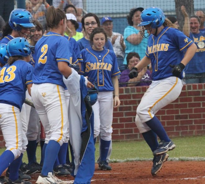 East Ascension's Tiffany Robinson hops to home plate, where her Spartans teammates await. East Ascension cruised past St. Joseph's Academy 7-1 Friday to earn a spot in the state Class 5A quarterfinals in Sulphur, set for this weekend.
