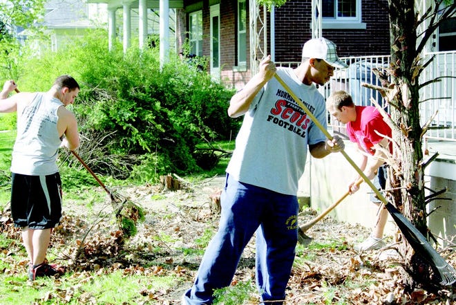 Submitted
Monmouth College football players Vinnie Miles, Deontrae Nelson and Nick Zigler cleared overgrown shrubs and removed brush for one Monmouth resident during the Fighting Scots’ Second Annual Cleanup Day. About 70 players worked at 17 different locations in one day, providing nearly 1200 man hours of volunteer labor over a four hour period.