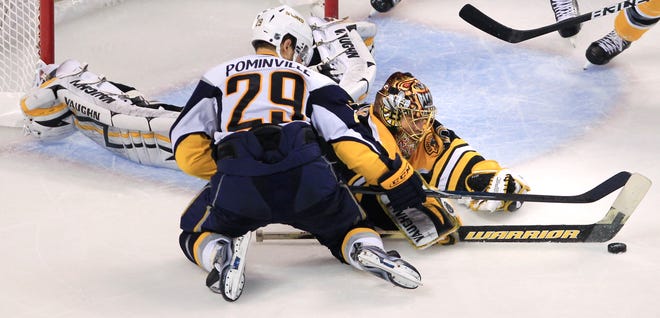 Bruins goalie Tuukka Rask dives to make a save against Sabres center Jason Pominville during the third period Monday.