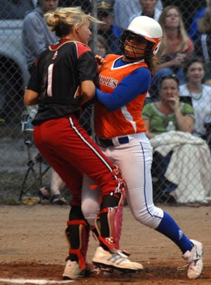 Bolles' Marley Ramirez (right) runs into Baker County catcher Alexis Branch and is called out on the play during a Region 1-3A softball quarterfinal game Tuesday. The game was suspended with Bolles leading in the fifth.