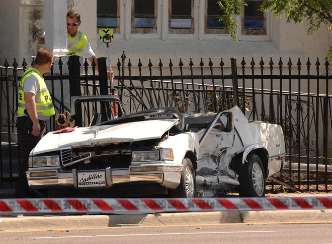 Traffic homicide investigators work at the scene of a Tuesday morning traffic fatality at the St. Philips Episcopal Church at West Union and North Pearl streets. The driver of the Cadillac was killed, and a passenger seriously injured when it collided with a truck at 9:27 a.m., police said.