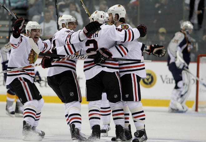 Chicago Blackhawks defenseman Duncan Keith (2) is congratulated by teammates after scoring against Nashville Predators goalie Pekka Rinne during the first period of Game 6 Monday, April 26, 2010, in Nashville, Tenn.
