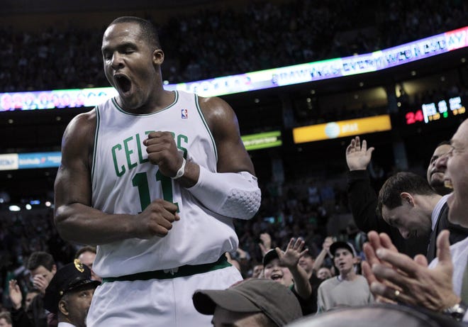Celtics forward Glen Davis celebrates with fans after Boston beat Miami to advance to the second round of the playoffs.