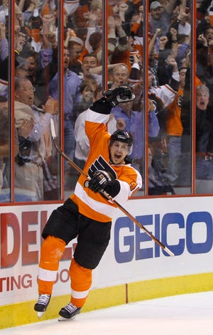 Philadelphia Flyers' Danny Briere celebrates his goal against New Jersey Devils' Martin Brodeur in the second period of an NHL first-round playoff hockey game, Tuesday, April 20, 2010, in Philadelphia. (AP Photo/Matt Slocum)