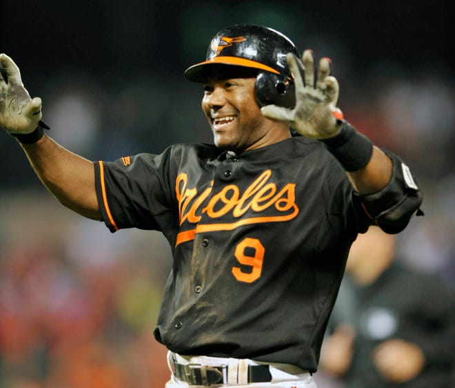 Baltimore's Miguel Tejada celebrates after driving in the winning run against the Red Sox last night.