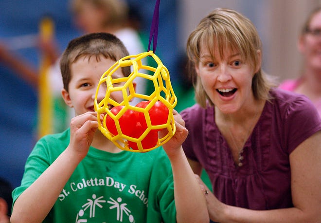 BRAINTREE 4/30/10 Special Olympics games at the St. Colleta Day School in Braintree, this was a regional event for area students. Nikita Bezvitny-12 of the Quincy takes a shot in tether ball bowling with cheering from his teacher Susan Durkin.

GREG DERR/ THE PATRIOT LEDGER