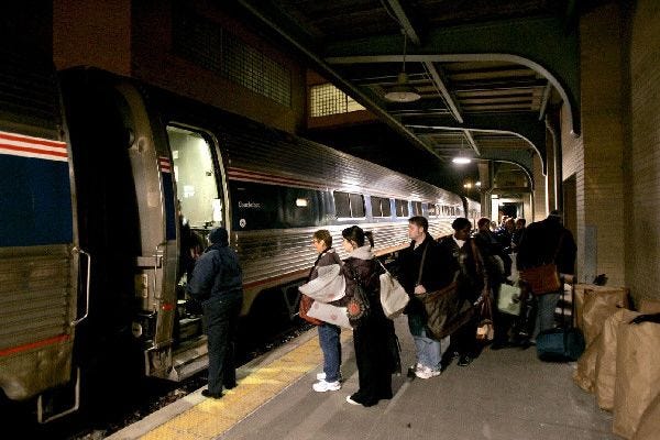 In this March 26, 2010 photo, passengers board the Lake Shore Limited before dawn at the Amtrak station in Toledo, Ohio.